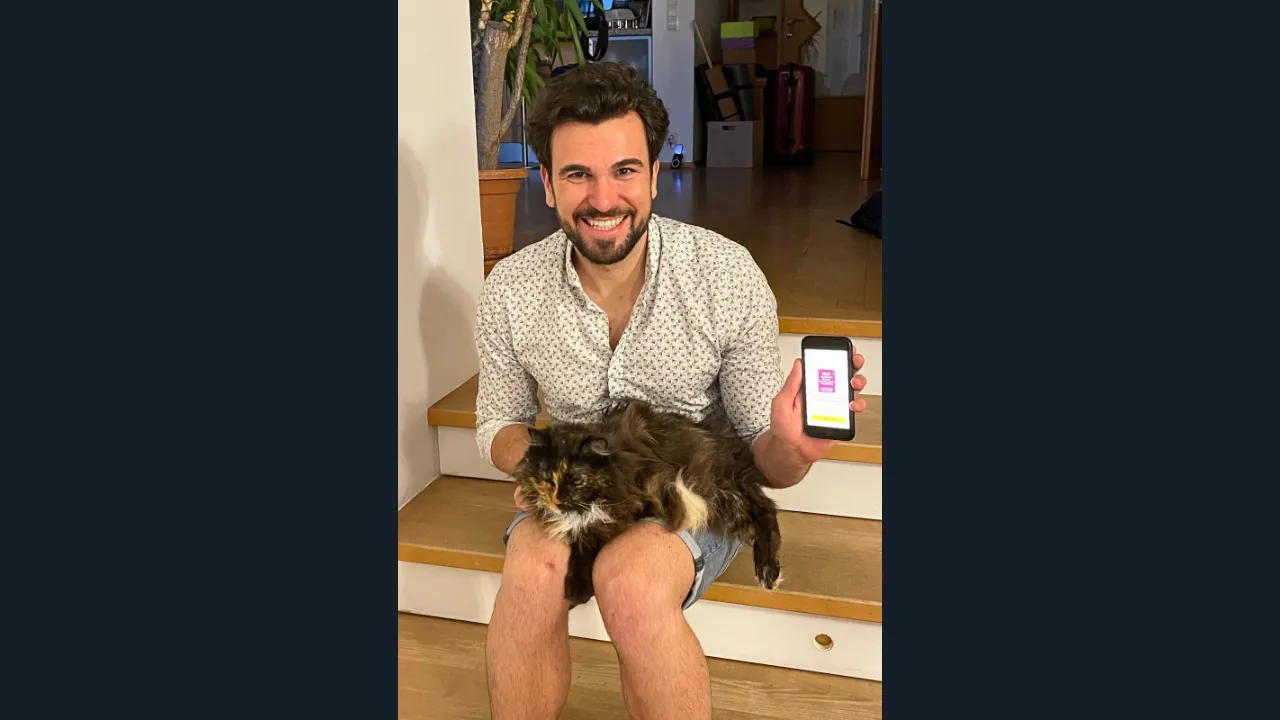 Person holding a phone displaying the Shortform app while sitting with a dog