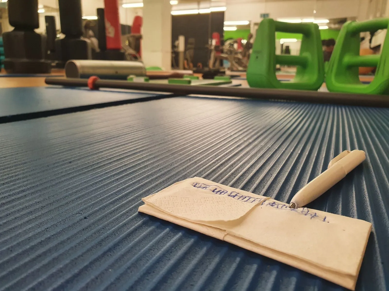 Handwritten tally marks on tissue paper tracking pushup sets
