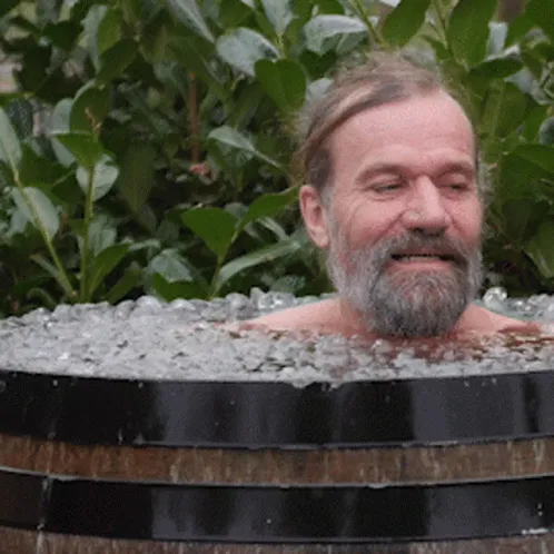 Man sitting in a wooden ice bath